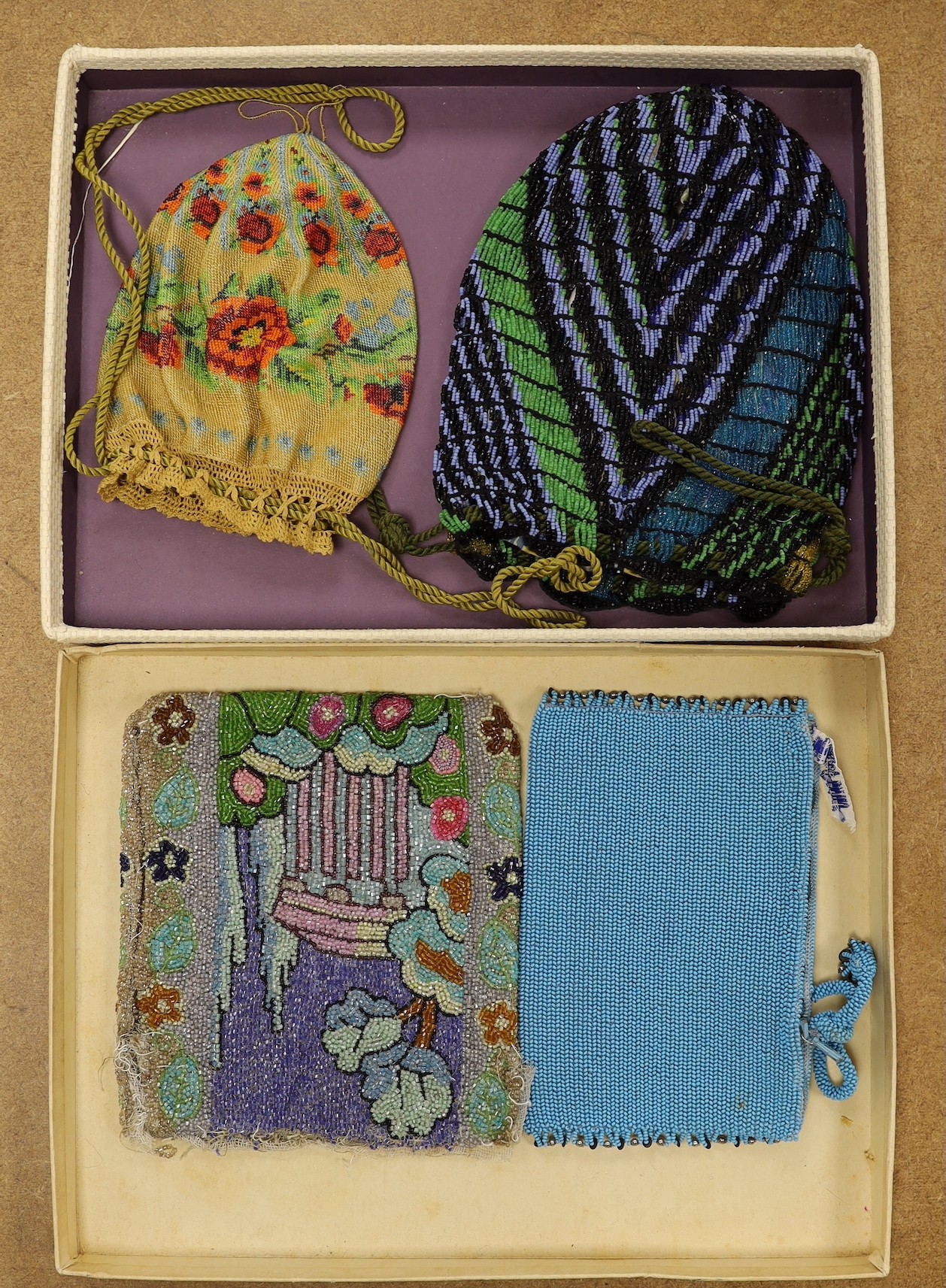 A late 19th century floral bead worked drawstring bag, a later jazz age beaded bag, a turquoise plain bead bag with zip and an unlined bead bag with a classical scene, (4)